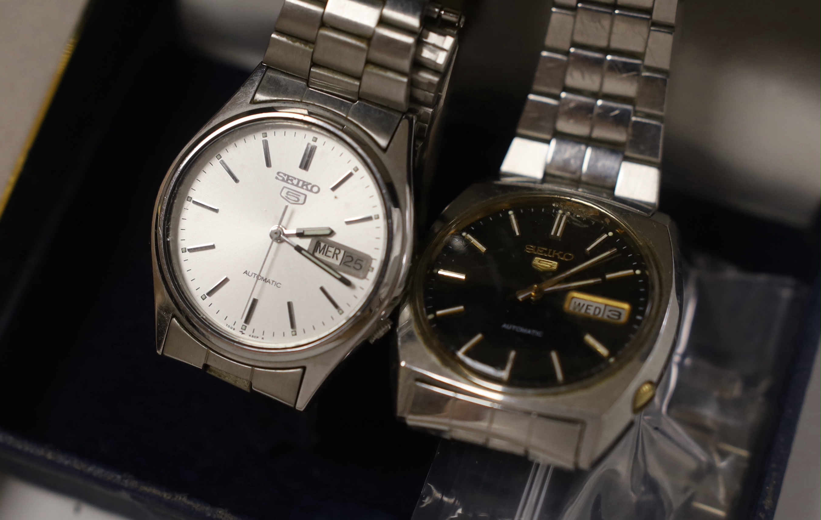 Three gentleman's stainless steel Seiko 5 automatic wrist watches including one with black dial and a Solar Star quartz wrist watch.